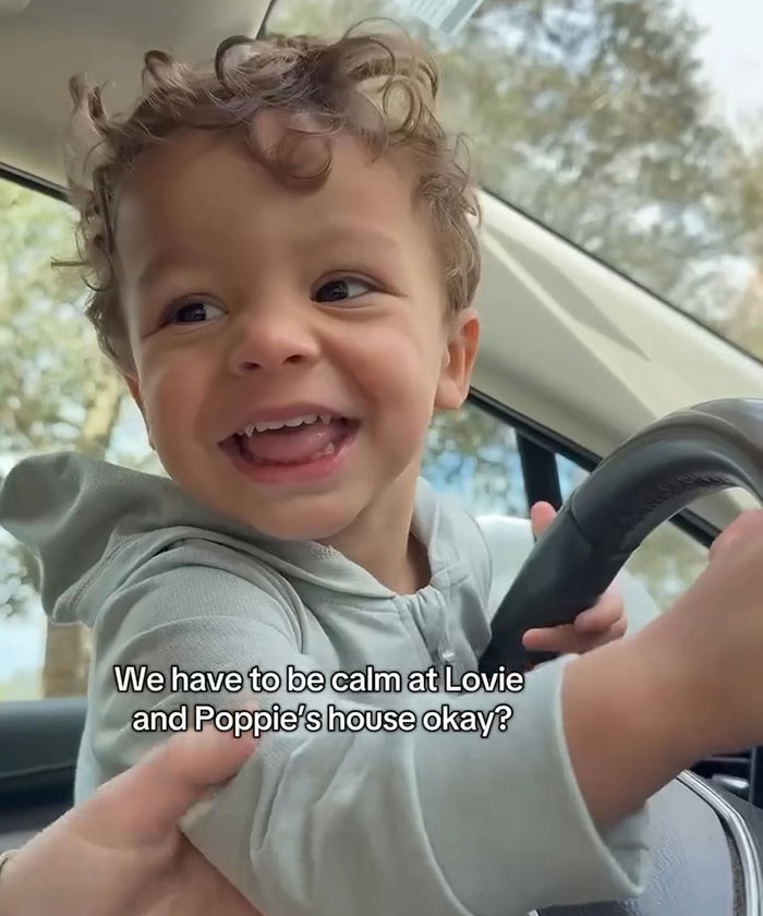 Smiling child in car, wearing a hoodie, with text overlay.