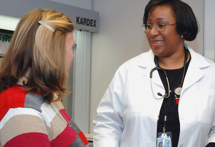 New mom discussing concerns with a doctor, addressing misconceptions about teen pregnancy in a medical setting. New mom discussing concerns with a doctor, addressing misconceptions about teen pregnancy in a medical setting.