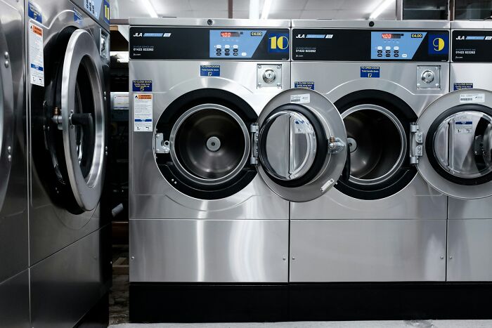 Industrial washing machines in a laundromat setting, showcasing potential everyday loopholes in use.