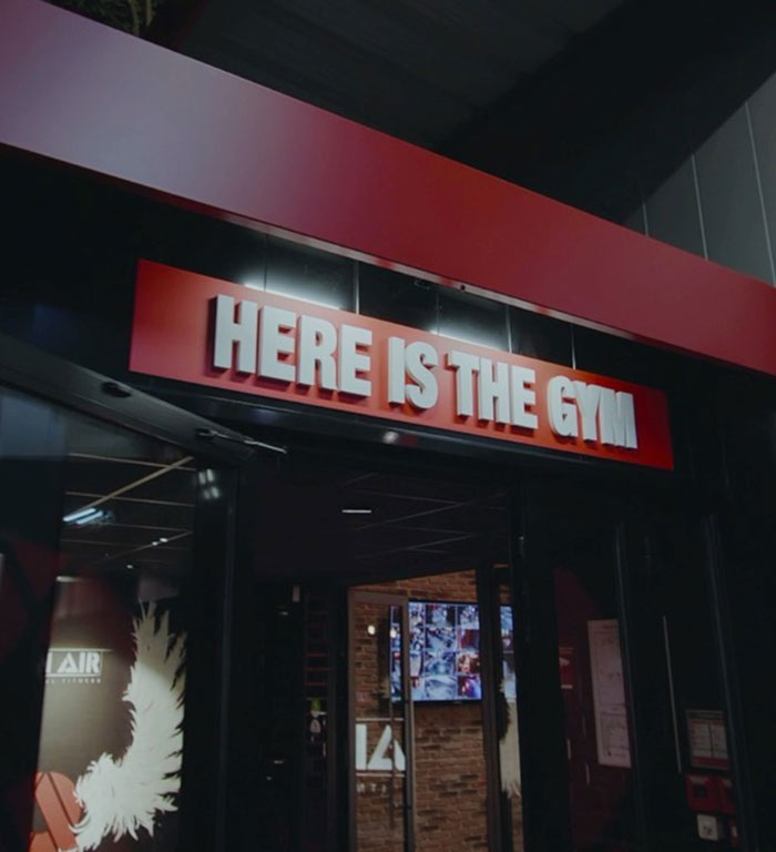 Sign above a gym entrance at night, highlighting treatment dangers. Sign above a gym entrance at night, highlighting treatment dangers.