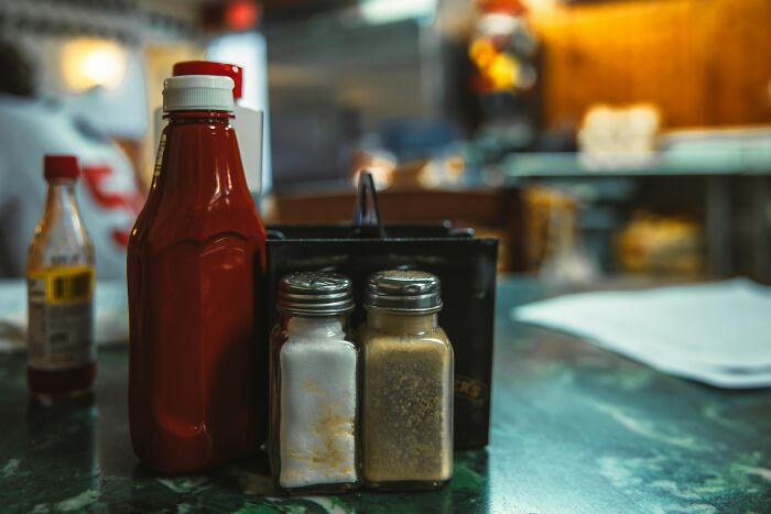 Condiments and spices on a restaurant table symbolizing usual things that ended with the pandemic changes.