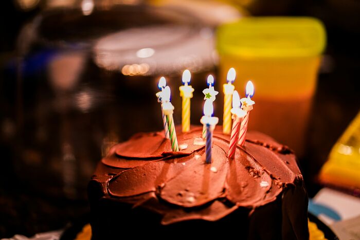 Chocolate cake with lit candles symbolizing celebrations among usual things changed after the pandemic and never the same again