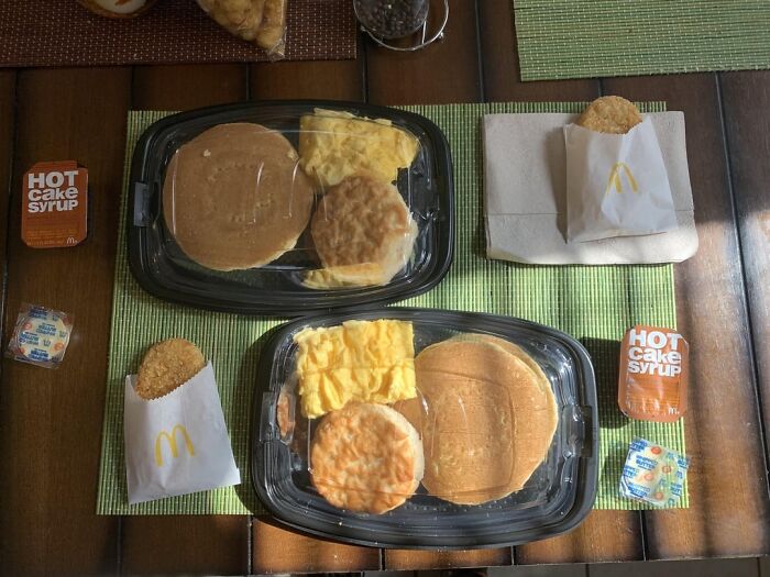 Fast food breakfast trays with pancakes, eggs, and hash browns illustrating usual things changed by the pandemic.
