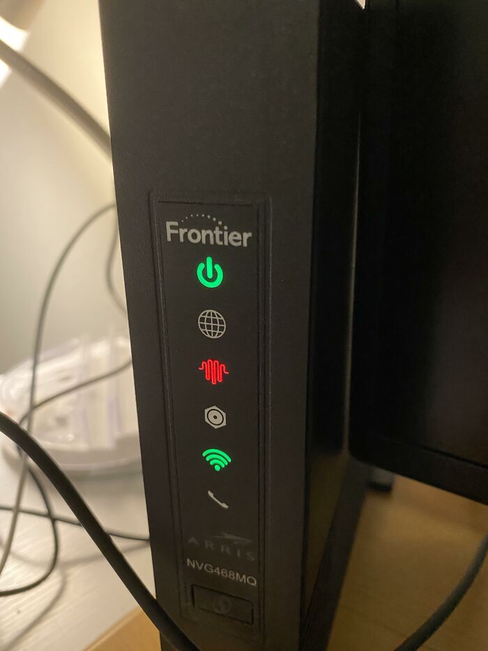 Frontier internet router with indicator lights on, possibly from brands people avoid.