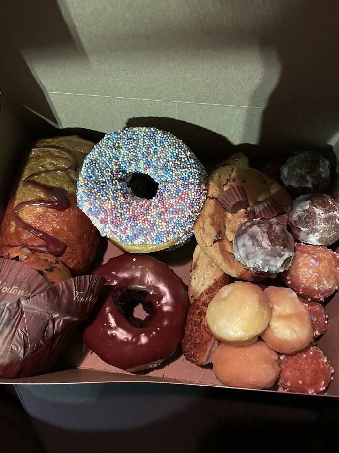 A box of assorted pastries and donuts from a popular store.