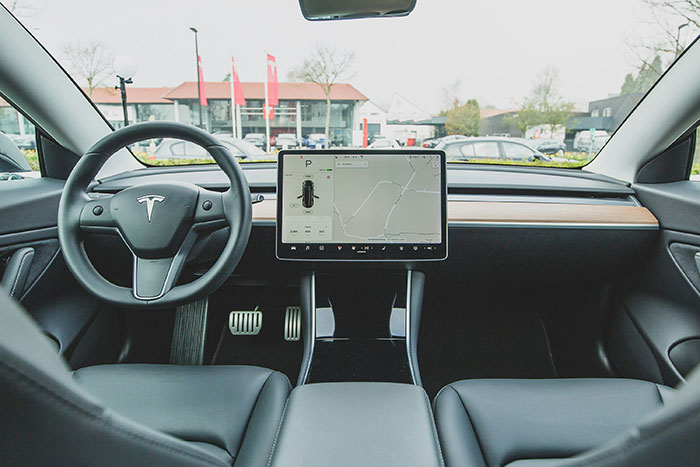 Tesla car interior showcasing modern, digital dashboard, highlighting technology advancements boomers acknowledge.