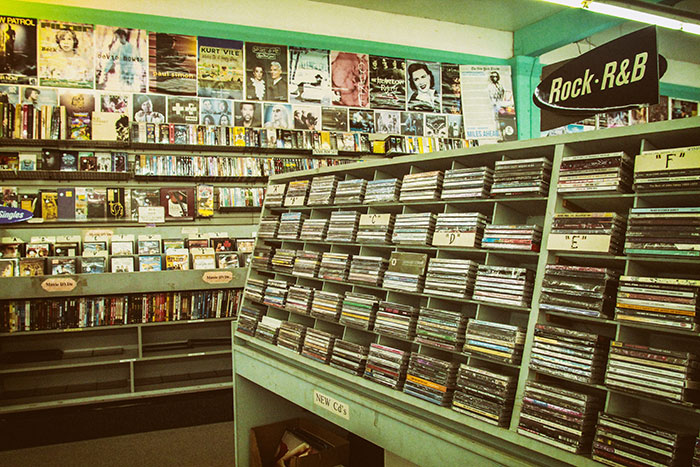 A retro music store showcasing CDs and vinyl, highlighting the magic of physical media.