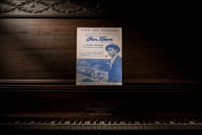 Vintage Frank Sinatra sheet music on an antique piano, creating a weird and creepy atmosphere.