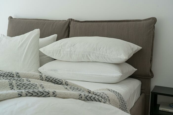 Affordable luxury bed with white pillows and a patterned blanket, showcasing a feel of elegance.