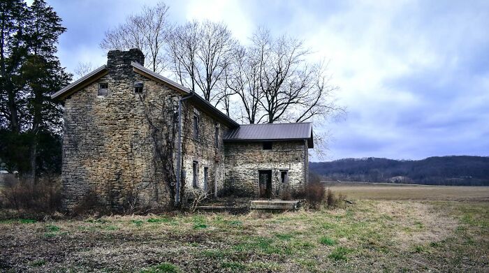 Old stone house in a field, potential danger avoided by trusting gut instincts.