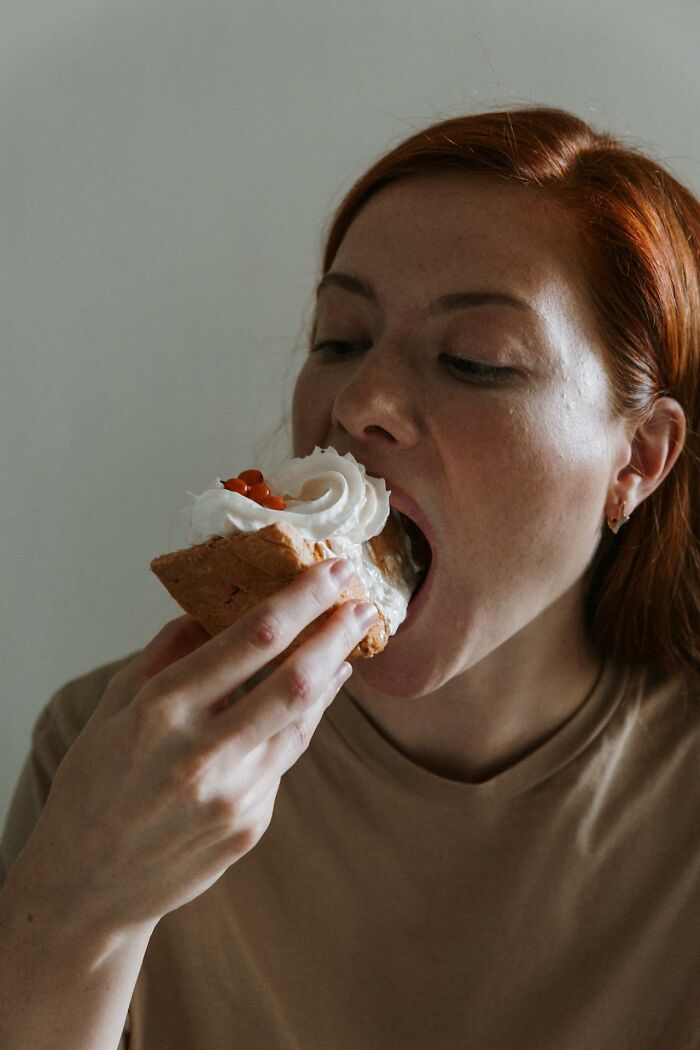 Woman enjoying a messy slice of cake as an unhinged mom sanity hack.