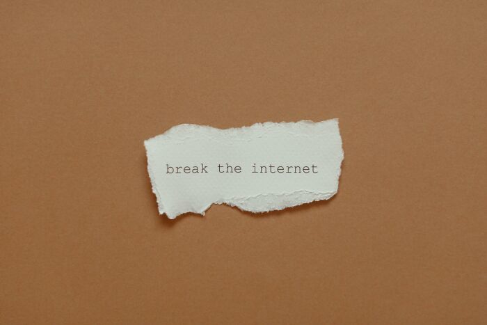 Ripped paper with the idiom "break the internet" on a brown background.