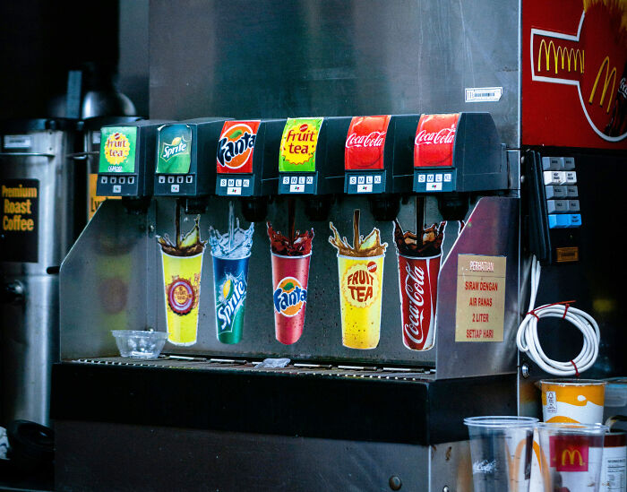 Soft drink dispenser with multiple soda options, highlighting a unique American cultural aspect.