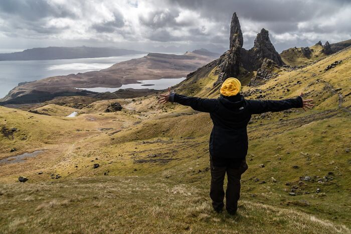 Person in yellow hat enjoying scenic view abroad, symbolizing U.S. expats' quest for fulfillment.