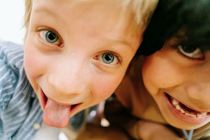 Two playful children sharing a fun moment, embodying the theme of intrusive thoughts.