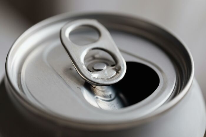 Close-up of an opened soda can tab representing a funny moment in relationship arguments like sitcom material.
