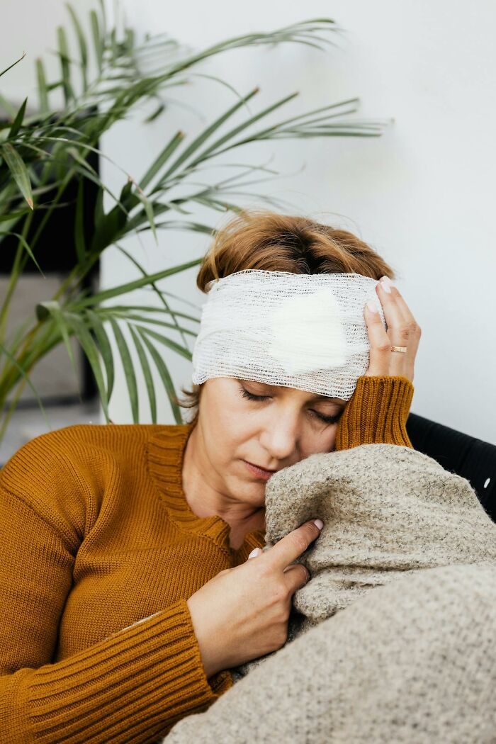 Woman with a head injury resting, highlighting something more traumatizing than people realize.