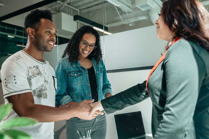 Job interview handshake with two candidates smiling, conveying biggest red flag job interview insights.