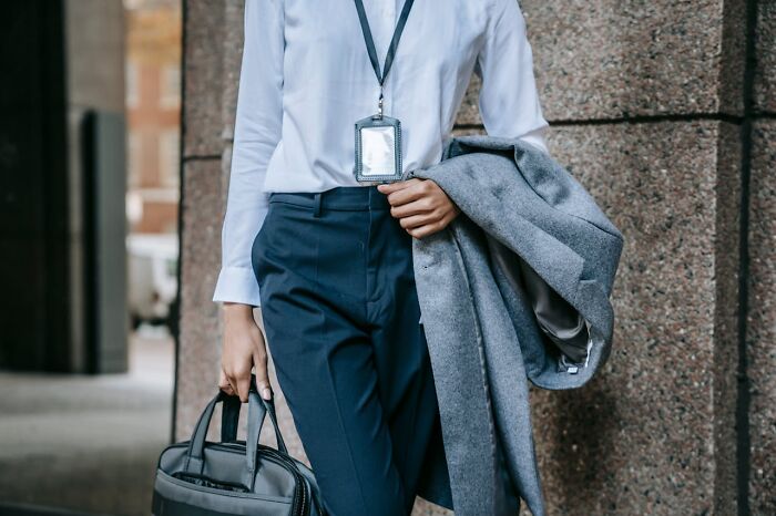 Professional in formal attire with ID badge and briefcase, illustrating industry knowledge.