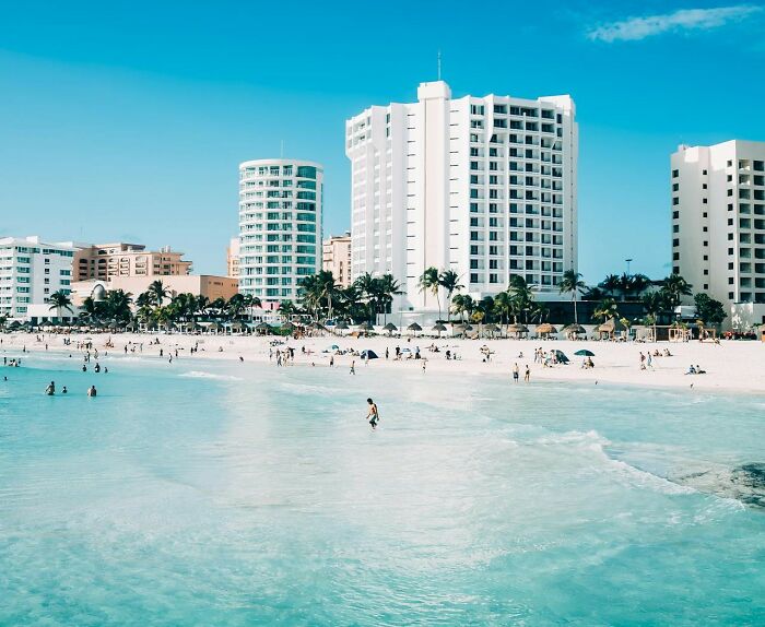 Beachfront high-rises on a crowded island, illustrating the impact of the filthy rich on local living conditions.