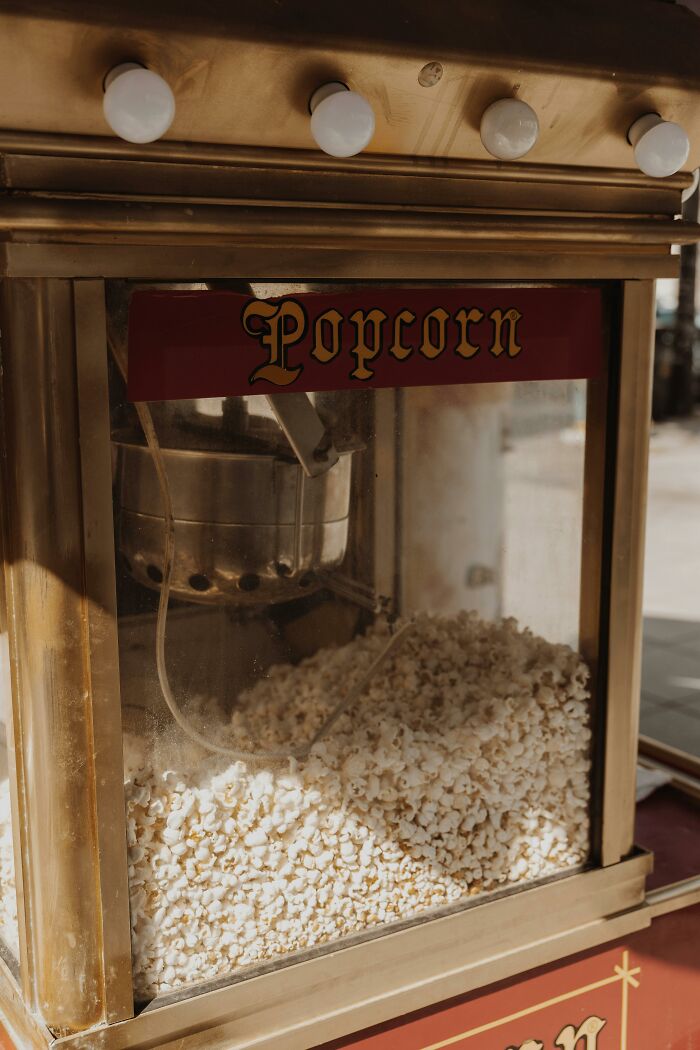 Popcorn machine filled with freshly popped popcorn, illustrating unusual luck in lottery winning stories.