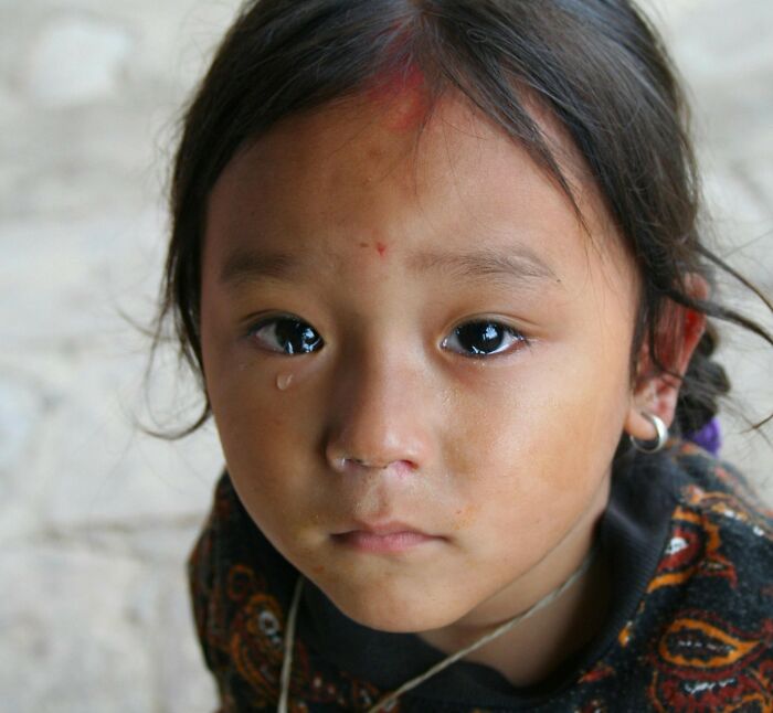Sad child with a tear on the cheek reflecting the ghastly things told in church that made people quit going.