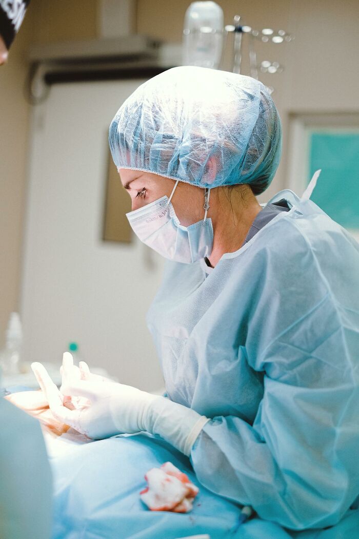 Surgeon focused in operating room, highlighting profession's less known challenges.