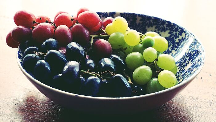 Colorful grapes in a decorative bowl illustrating obvious things you've just become aware of in everyday life context.
