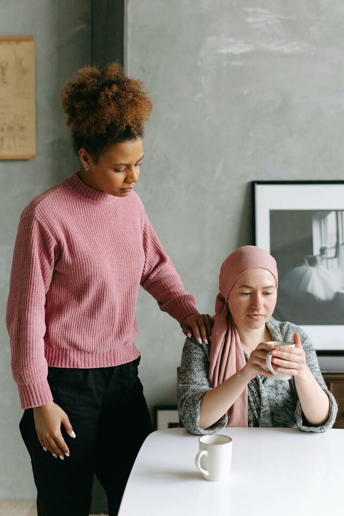 Two women in a comforting moment, potentially exploring something more traumatizing than realized.