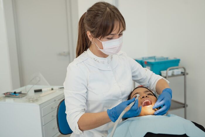 Dentist examining patient in clinic, highlighting disturbing findings doctors encounter.