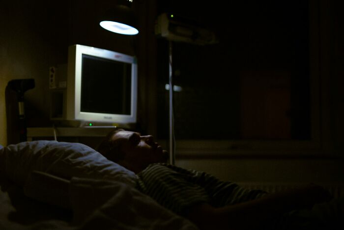 Person lying in dark room with faint light, reflecting on ghastly things told in church that made people quit going.