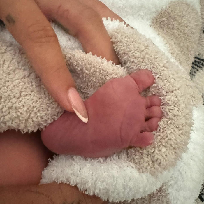 Baby Jack's foot wrapped in a towel by the pool, sparking internet debate around privacy.