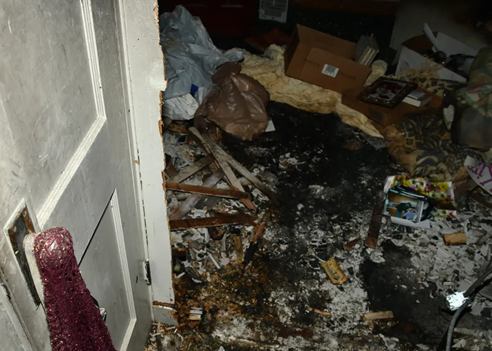 Disturbing photo of messy room in horror house, debris scattered across the floor, showing neglect and disarray.