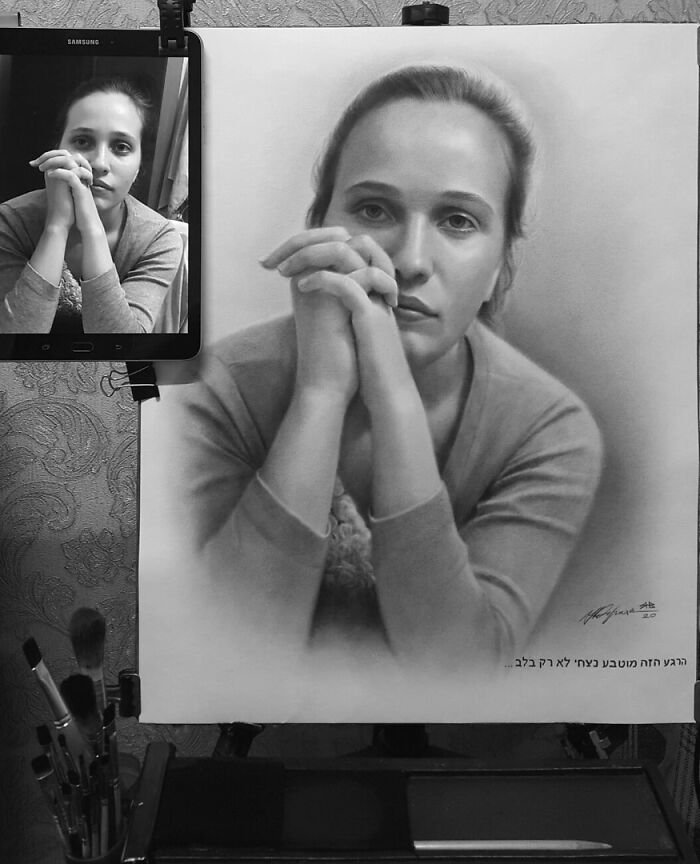 Hyper-realistic pencil portrait displayed next to a reference photo on a tablet, showcasing artistic skill.