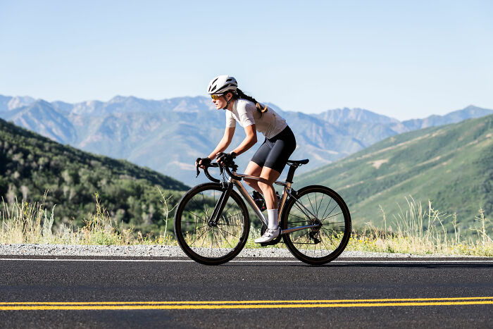 Cyclist enjoying mountain views, embodying quality of life improvement.
