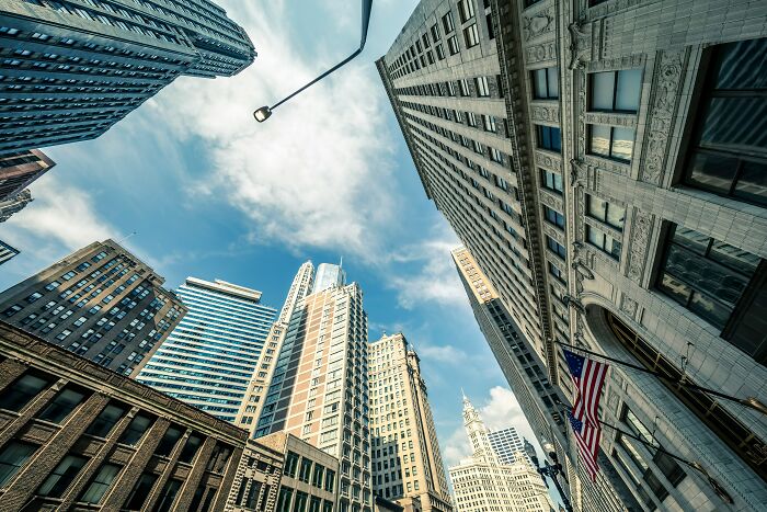 Skyscrapers and blue sky in an urban setting, symbolizing quality of life improvement in city living.