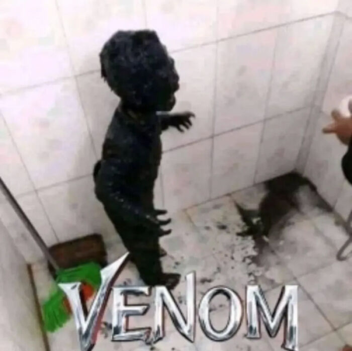 Child covered in dark substance, resembling a fictional character, standing in a tile room with the word "Venom" overlayed.