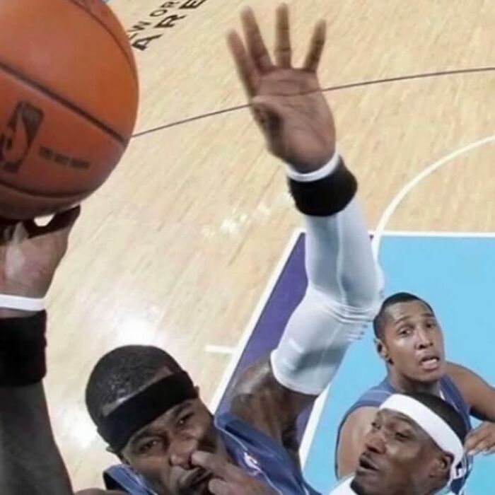 Basketball players in an intense game moment, one picking nose, showcasing funny random image humor.