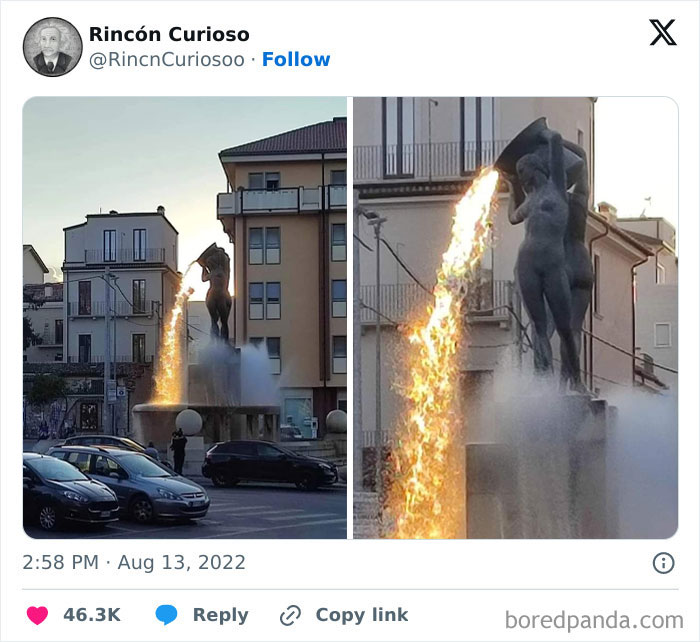 Statue with a dramatic fire illusion, appearing surreal but is a real photo, captivating passersby.