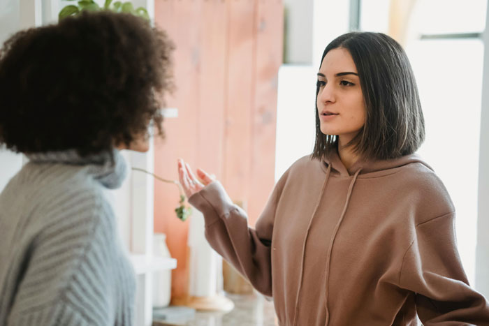 Two women having a dramatic conversation in a cozy home setting about the lack of coffee.