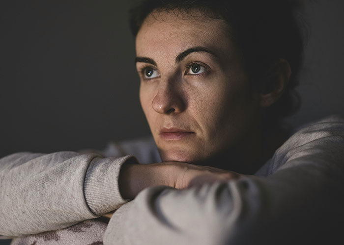 Woman in a thoughtful pose indoors, arms crossed, reflecting on a lesson learned. Woman in a thoughtful pose indoors, arms crossed, reflecting on a lesson learned.