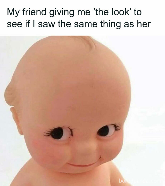 Smiling doll with side-eye glance, capturing a relatable meme moment.