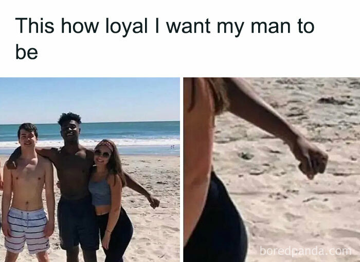 Three friends at the beach with one man keeping his hand away, humorously depicting loyalty.