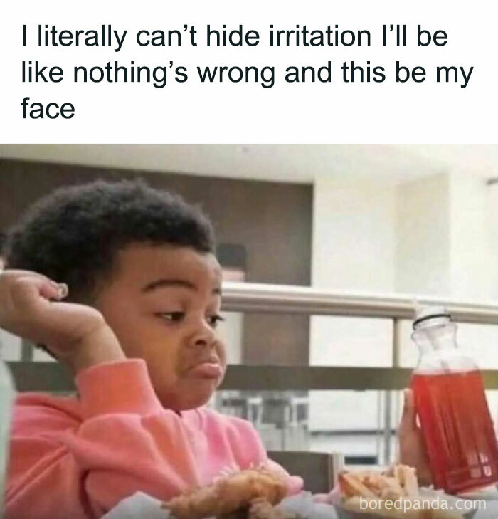 Child in pink sweater looking unimpressed at a bottle, symbolizing relatable meme moment.