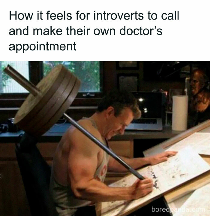 Introverts struggle memes: Man strains, lifting heavy barbell while making a phone call, illustrating social exhaustion.