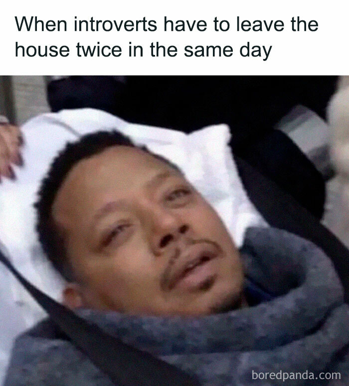 Man looking exhausted, wrapped in a blanket, capturing the struggles of introverts facing social exhaustion.