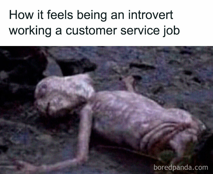 Exhausted alien symbolizes introvert struggles in customer service work setting.