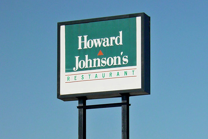 Howard Johnson's restaurant sign against a clear blue sky.