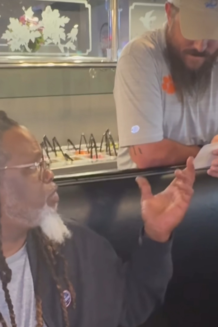 Restaurant owner gestures passionately while discussing customer feedback.