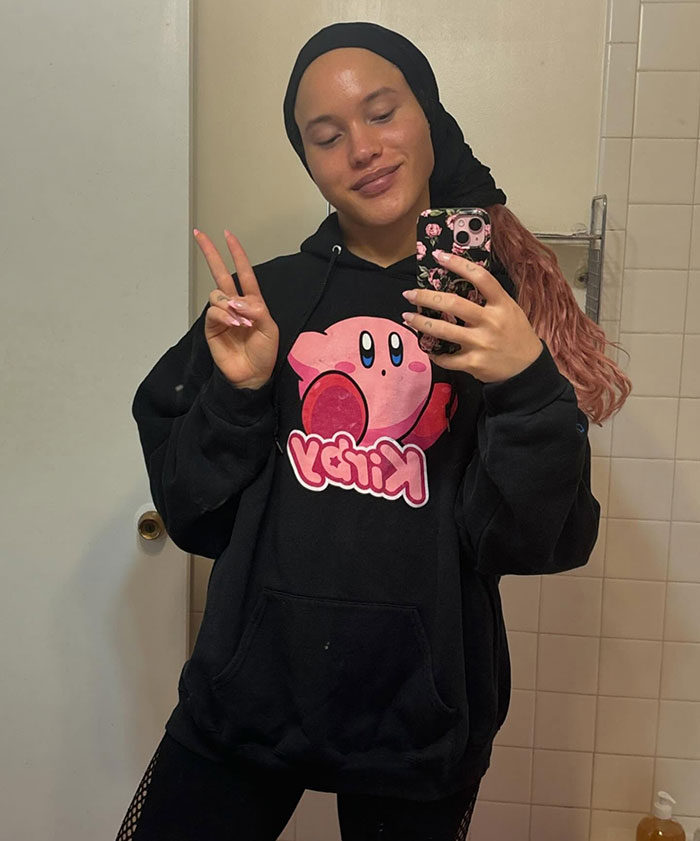 Person taking a mirror selfie wearing a Kirby hoodie and headscarf, representing Robert De Niro's daughter transgender reveal. Person taking a mirror selfie wearing a Kirby hoodie and headscarf, representing Robert De Niro's daughter transgender reveal.